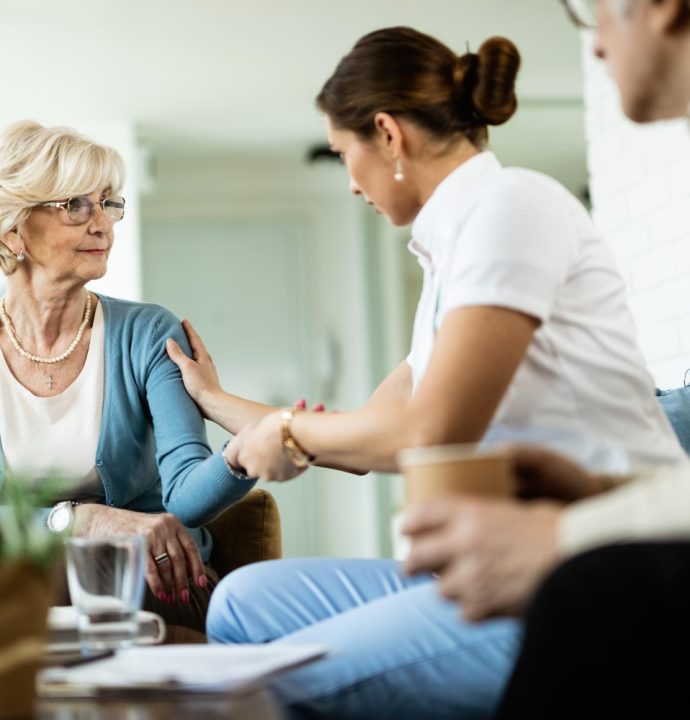 female-nurse-communicating-with-senior-woman-while-being-home-visit-focus-is-senior-woman